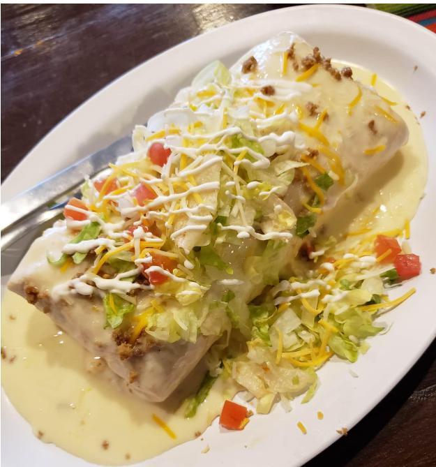 Burrito Supreme · Huge flour tortilla stuffed with ground beef and shredded pork in tomato sauce with rice and beans.
