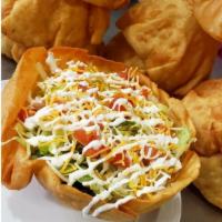 Taco Salad · Choice of ground beef or shredded chicken with lettuce, tomatoes, refried beans, sour cream ...