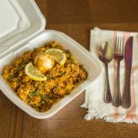 Goat Biriyani · Comes with rice, onions, egg, cilantro, lemon and Indian spices (raita included).
