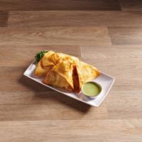 Samosas · 4 pieces. Home-made tortillas with a potato and herb filling.