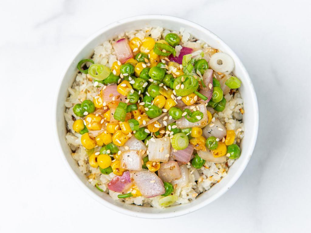 Cauliflower Fried Rice · Roasted cauliflower rice, peas, corn, green onions and sesame seeds with our house-made ginger garlic sauce and a protein of your choice. Gluten-free.