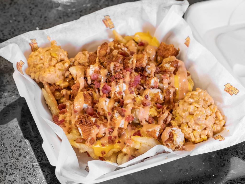 Loaded Bomb Bowl · half a pound  of handcrafted chicken tenders served on top of your choice of mac and cheese or cheese fries, bacon, street corn and a bomb sauce drizzle.