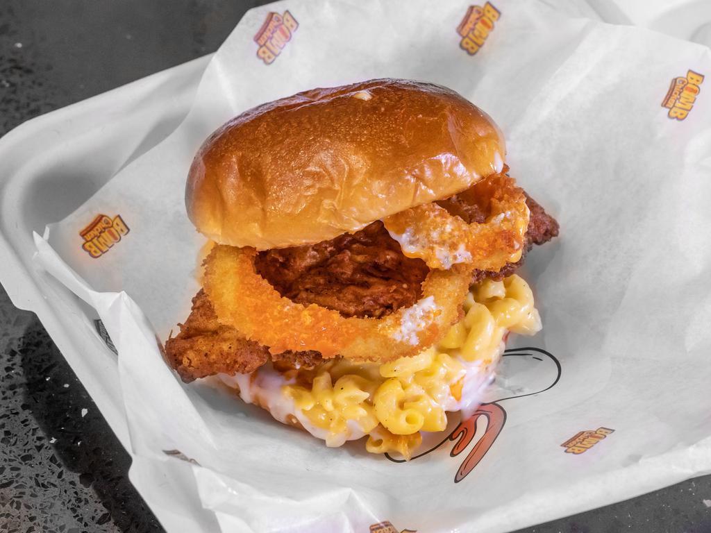 The Mac Bomb Sandwich · Quarter a pound of handcrafted chicken tenders, mac and cheese, onion rings, Buffalo and blue cheese sauce on a toastd brioche bun.