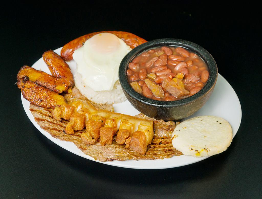 Bandeja Paisa · Grilled steak or ground beef, sweet plantains, beans, pork belly, arepa and rice topped with a fried egg.