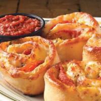 Pepperoni Rondos · Oven-baked blossoms of pizza dough brushed with garlic-pesto sauce, stuffed with provolone c...