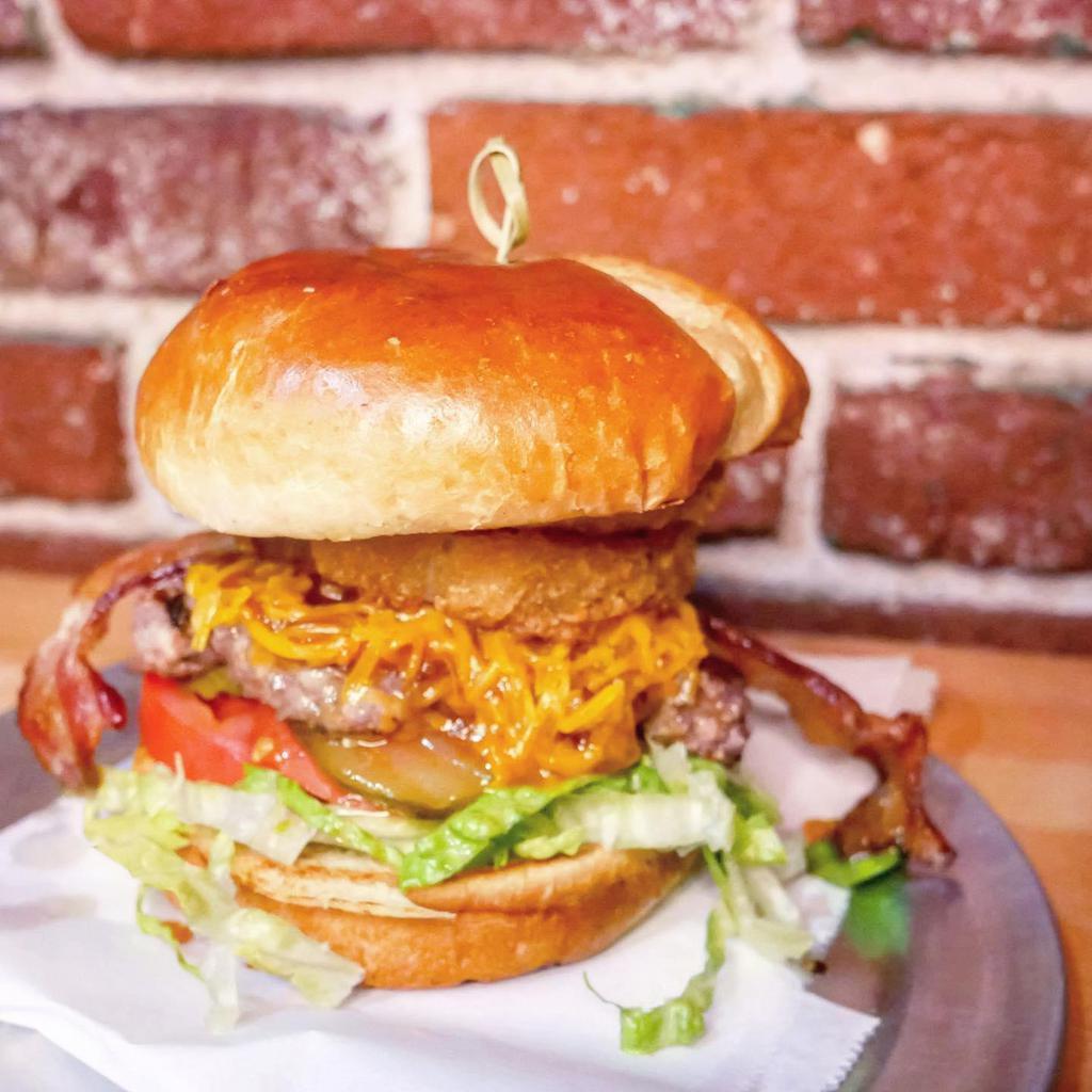 BBQ Bacon Cheeseburger · 1/3 lb. ground beef patty, bacon, 2 onion rings, BBQ sauce, lettuce, tomato, onions, pickles, and cheddar cheese.