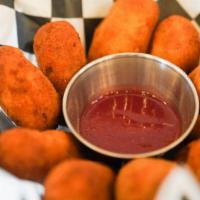 Bolinho de Bacalhau · Mashed yuca croquettes with cod fish and herbs , comes onion aioli sauce, or blackberry haba...