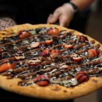Brownie Brittle Pizza · A Combination of all our fan favorites, condensed milk, rich Lindt chocolates accented with ...