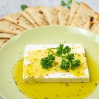 Feta Ladorigani (Feta Cheese) · A slice of feta cheese topped with extra virgin olive oil and oregano.
