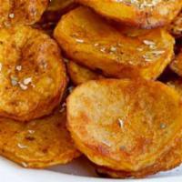 Potato Fritters · Fresh cut potato sliced thin, coated in a garlic pepper seasoning, and fried golden.