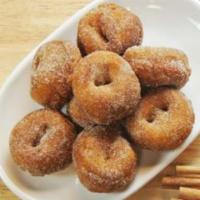 Mini Churro Donuts · 8 donuts. Fried golden and coated in cinnamon sugar. Vegetarian.