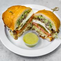 Torta (Mexican Sandwich) · Mexican sandwich. Telera bread with choice of meat, mayo avocado onions tomato lettuce beans...