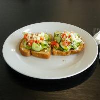 Avocado Toast · Avocado, tomato, cucumber, crumbled feta, extra virgin olive oil & cilantro.