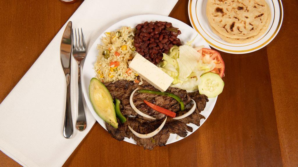 Carne Asada · Grilled beef steak served with salad, avocado, cheese, lemon, rice, beans and tortilla.
