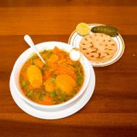 Sopa de Mondongo · Beef tripe soup with vegetables served with tortillas.