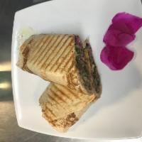 Lamb Shawarma Sandwich · Marinated thin slices of lean lamb and beef broiled to perfection and shaved. Served wrapped...