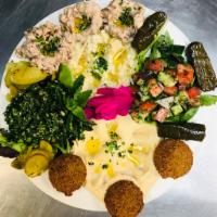 Vegetarian Combo Plate · A medley of hummus, baba ghanouj, tabouli, salad, 2 pieces grape leaves and 2 falafel balls....
