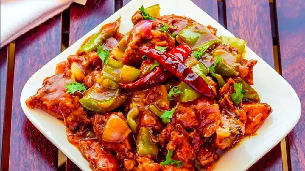 Chilli Chicken · Cubes of chicken prepared with corn flour, chili paste, soy and bell peppers. Served with sauces and chutneys.