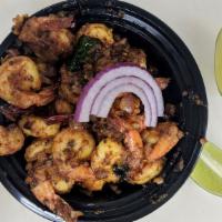 Pepper Shrimp · Crisp fried cut pieces of prawns tossed with onions and chilies.