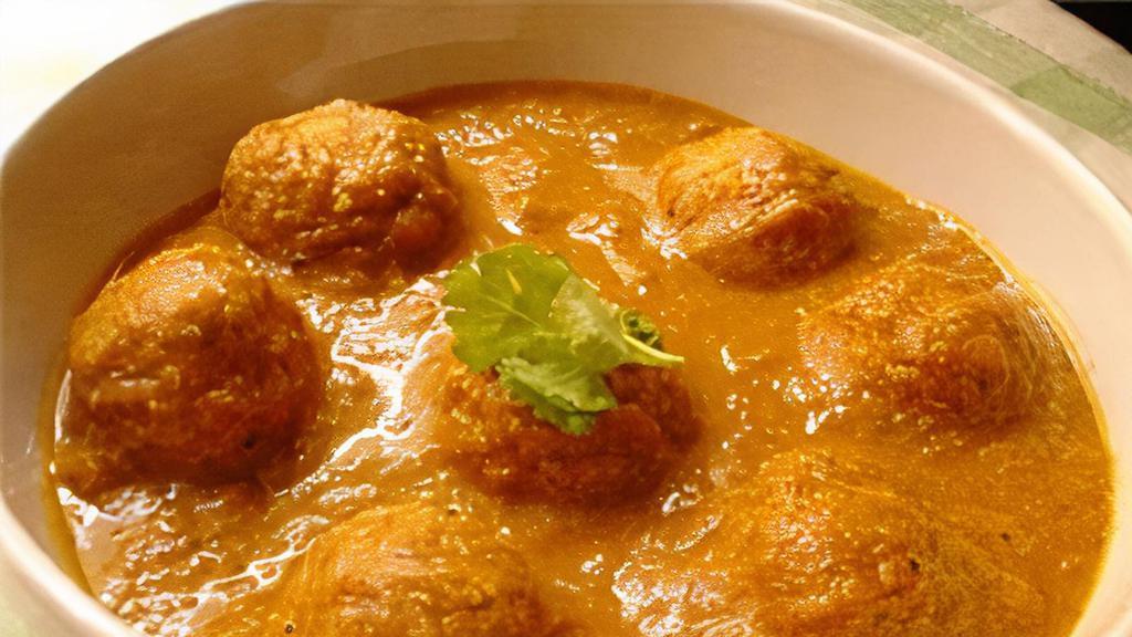 Malai Kofta · Deep fried dumplings made with mix vegetables, Cottage cheese, dry fruits cooked in a creamy sauce.