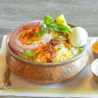 Hyderabadi Chicken Dum Biryani · Long grain basmati rice flavored with saffron is cooked in a traditional Hyderabadi style wi...