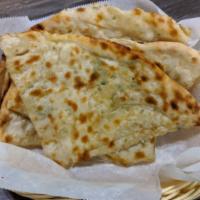 Onion Kulcha · White breed stuffed with onion and baked in our clay oven and lightly buttered.