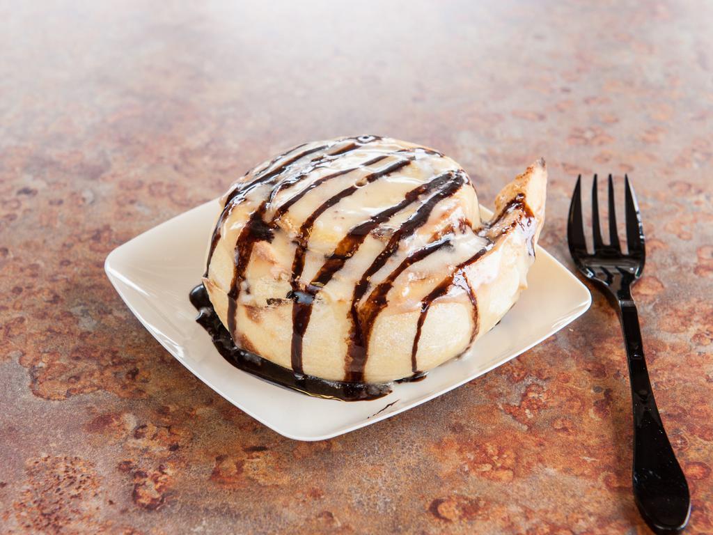 Peanut Butter Roll · Peanut butter, chocolate chips and brown sugar, topped with cream cheese frosting.