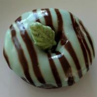 Mint Chip  · Mint chocolate donut, topped w/mint icing, chocolate ganache drizzle, and a mint chocolate c...