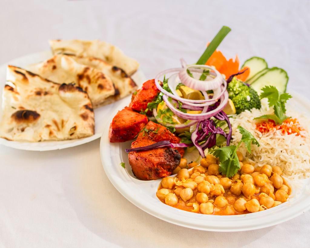 Boneless Chicken Kabob · Boneless and skinless fat-free pieces of chicken breast, marinated with our special herbs and spices.  All kabobs are grilled with a skewer over an open flame and are served with basmati rice or tandoori naan,