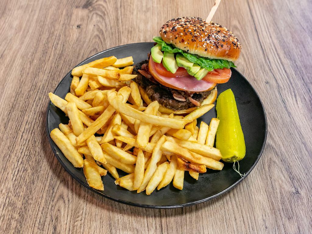 Guayoyo Burger · Beef or chicken, egg, bacon, ham, cheese, tomato, lettuce, avocado, with French fries and whole pickle, mayonnaise, ketchup, mustard & french fries.