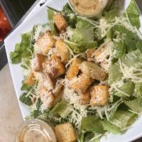 Caesar Salad · Romaine lettuce tossed in Caesar dressing with shredded mozzarella, Parmesan cheese and crou...