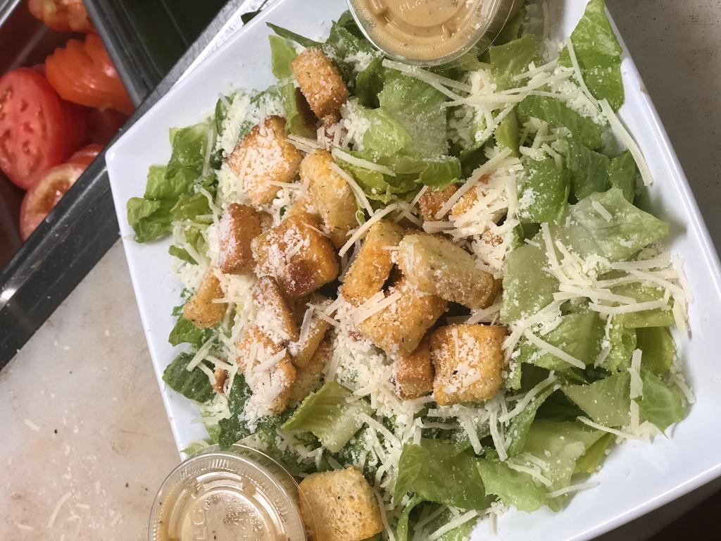 Caesar Salad · Romaine lettuce tossed in Caesar dressing with shredded mozzarella, Parmesan cheese and croutons.