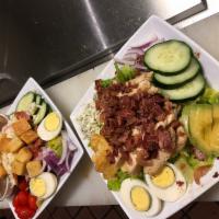 Cobb Salad · Romaine lettuce, tomatoes, onions, hard-boiled egg, bacon, crumbled blue cheese, avocado, gr...