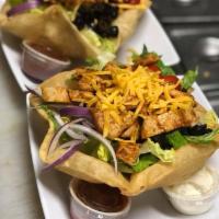 Taco Salad · Choice of beef, chicken or chili in a fried tortilla bowl with romaine lettuce, tomatoes, on...