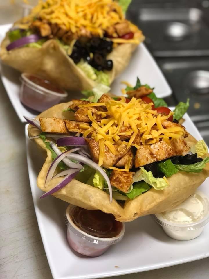 Taco Salad · Choice of beef, chicken or chili in a fried tortilla bowl with romaine lettuce, tomatoes, onions, black olives and shredded cheddar cheese. Served with sour cream, salsa and jalapenos on the side.