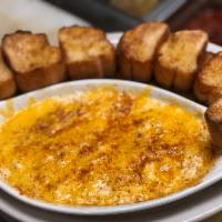 Crab Dip · Crab dip topped with cheddar cheese and Old Bay served with Old Bay Toast.