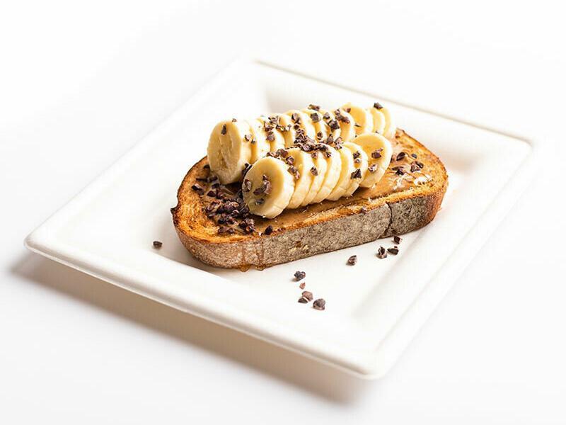 Banana Almond Butter Toast · Organic whole wheat bread, almond butter, sliced banana, cacao nib, and drizzled honey. Add gluten-free bread for an additional charge.