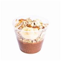 Chocolate Chia Pudding · Cacao chia topped with pumpkin seed & flax granola, banana and sliced almond