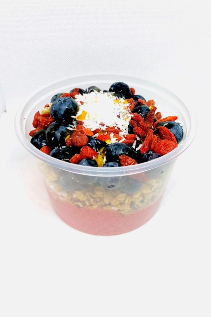 Dragon Fruit Bowl · banana, pineapple, avocado, oats and pitaya blended together and topped with pumpkin seed and flax granola, blueberry, goji berry and coconut shreds