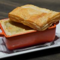 Craft Pot Pie · Baked puff pastry stuffed with poached chicken breast, carrots, potatoes, onion, and peas in...