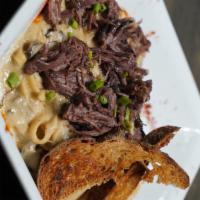 Beef Stroganoff · Fettuccine tossed in rich mushroom cream sauce, pulled short rib, topped with shredded Parme...
