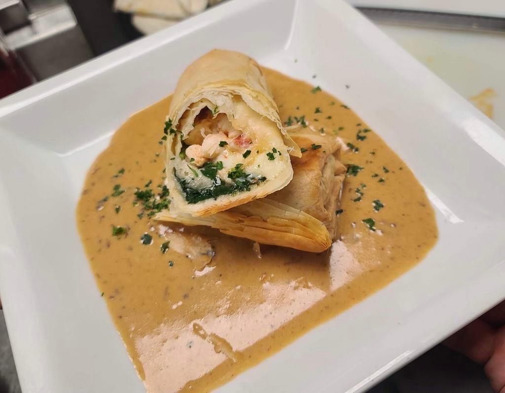 Lobster Roll · Filo dough wrapped lobster, spinach and manchego cheese. Served with chipotle crema.