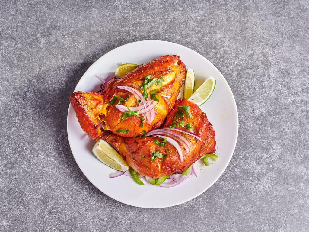 Tandoori Chicken · Gluten Free. One Breast one leg piece. Spicy chicken with yogurt, ginger, garlic, and spices and char grilled in the tandoor grill.