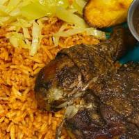 Jerk Chicken · Jerk Chicken served with Jollof Rice or Rice and peas, and sides of the day.
