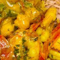 Coconut Curry Shrimp · Sautee coconut shrimp served with jollof rice or rice and peas and sides.