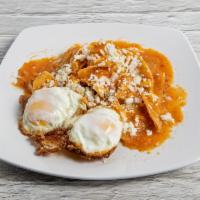 Mexican Chilaquiles · Fried tortilla soaked with a sauce of your choice. Served with sour cream, cheese, and raw o...