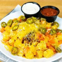 Tater Tot Fiesta · Taco beef, golden brown tater tots smothered in jack cheddar cheese, tomatoes, jalapenos, se...