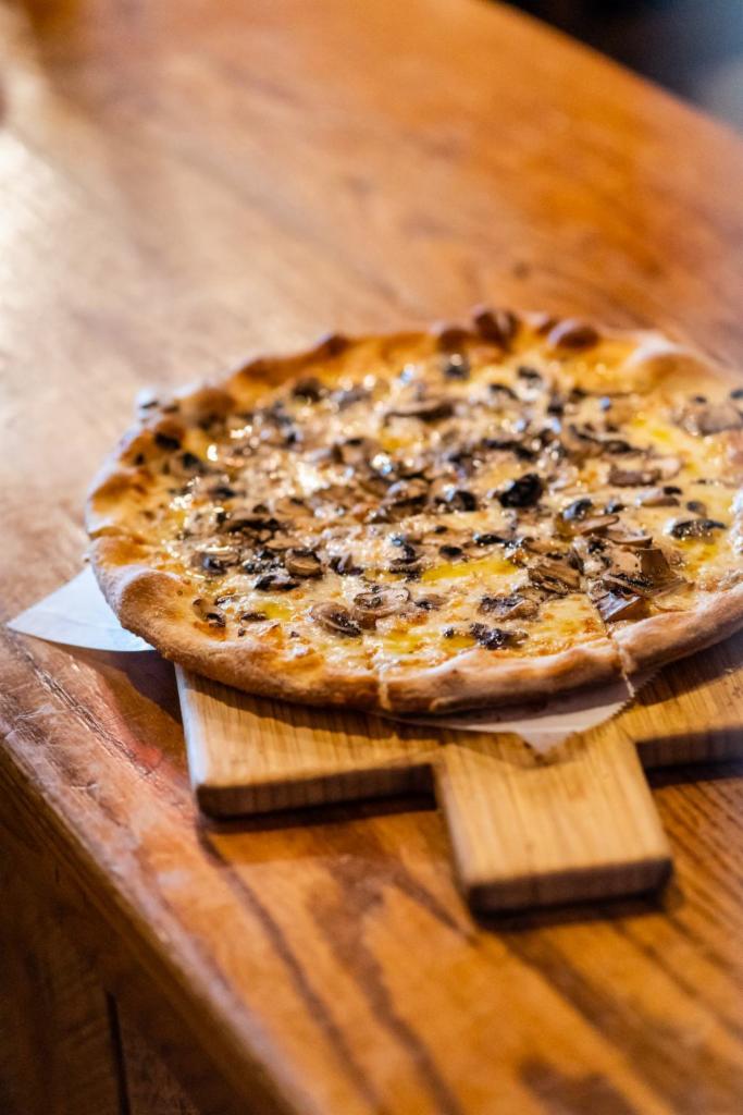 Tartufo Pizza Personal · Shredded mozzarella, wild mushrooms, truffle oil.