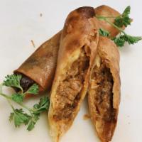 Pastele lumpia · Slow cooked pork with cilantro, onion, black olives, green bell pepper and Hawaiian chili pe...