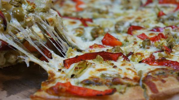 5. Mediterranean Pizza · Pesto sauce, mozzarella, feta, artichoke hearts, green olives, and red bell peppers.
